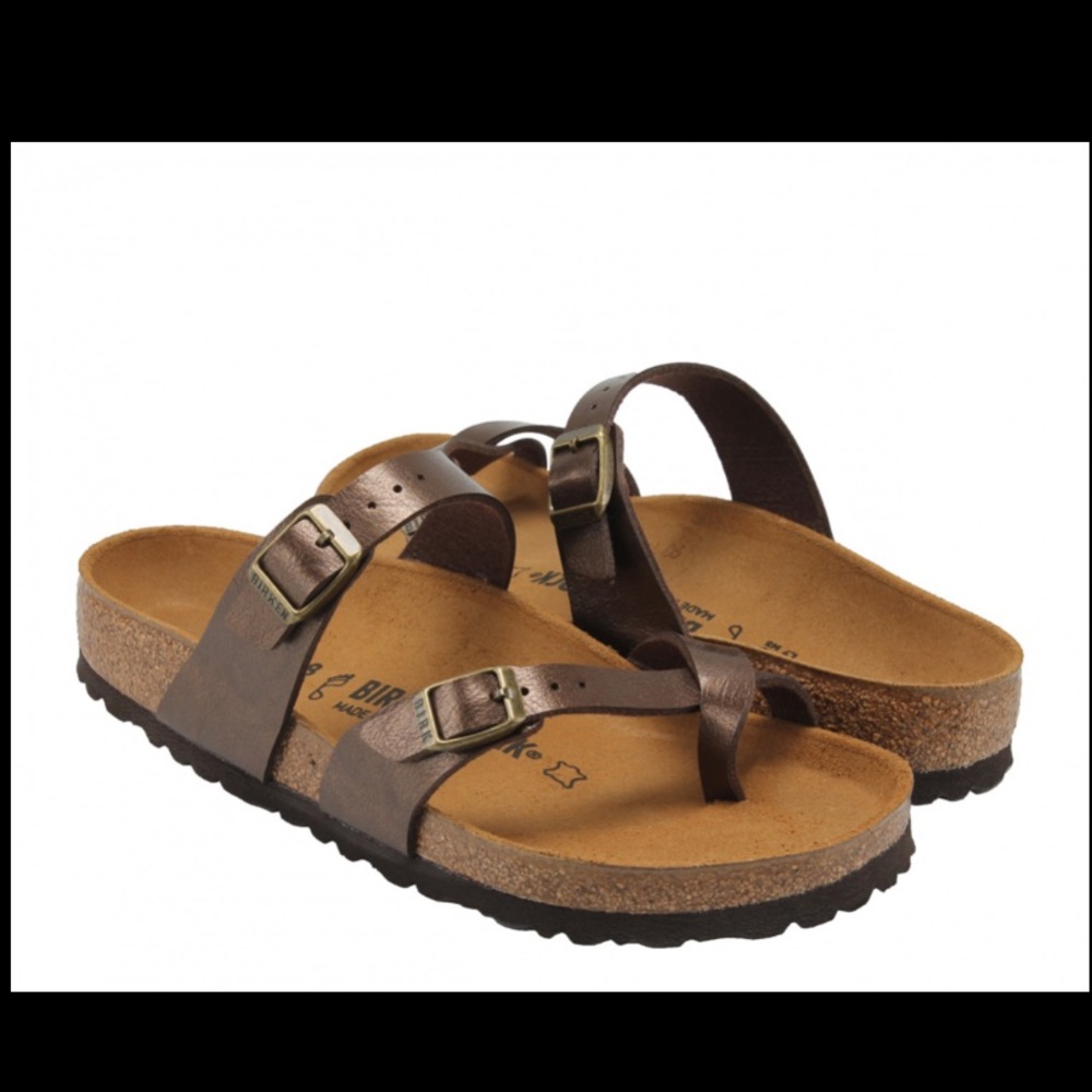 Brown four toe Birkenstock sandals.